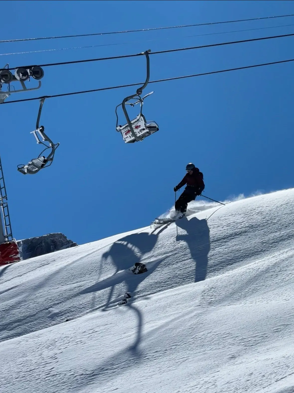 Skier carving downhill at a Chilean Andes resort