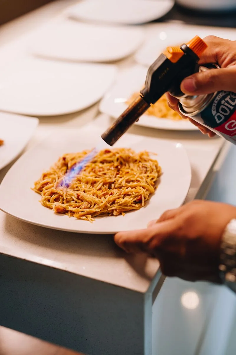 Chef flambéing a signature dish live